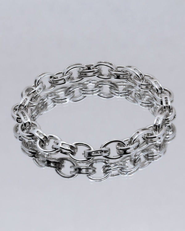 woman wearing two yellow gold bracelets with hearts