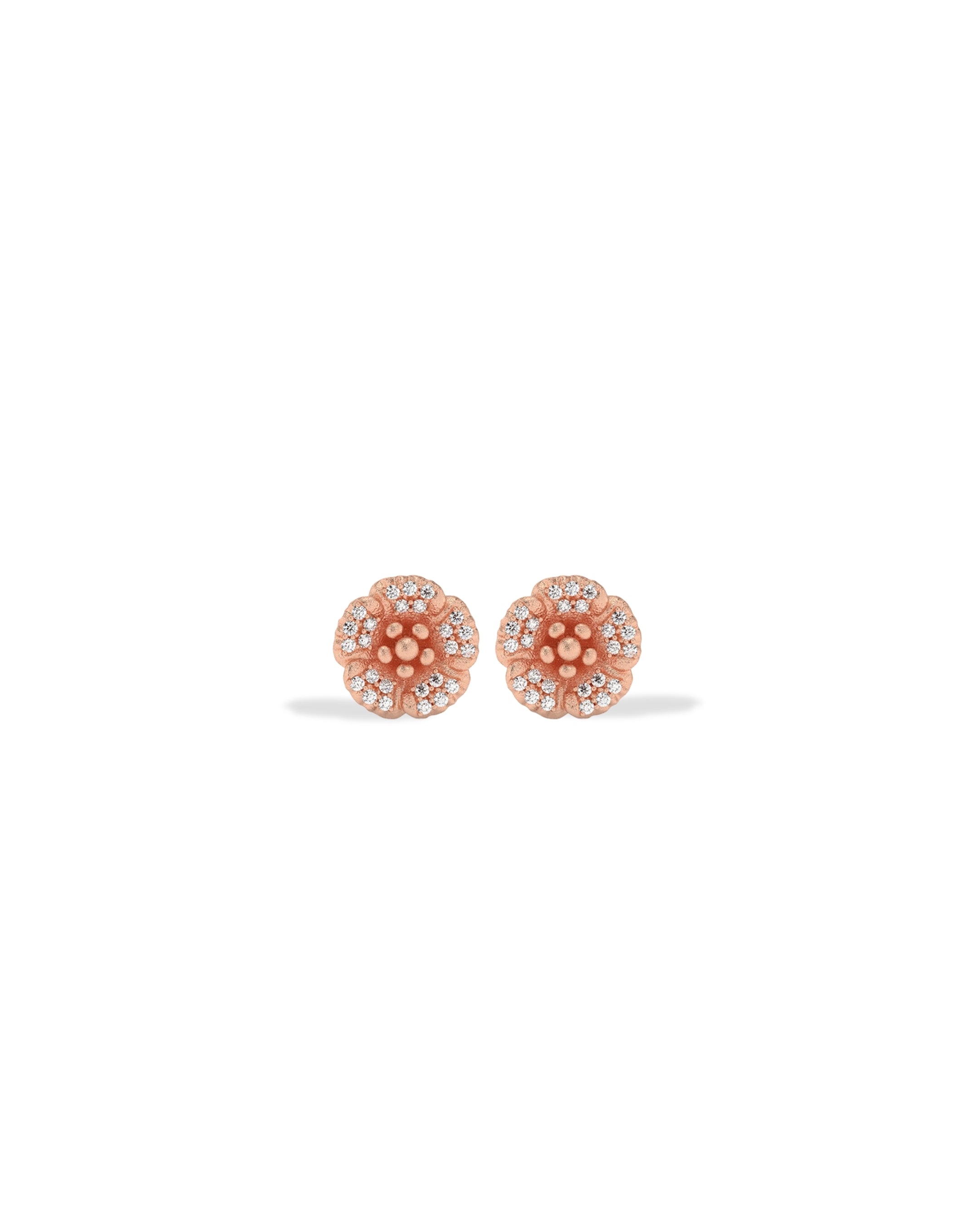 Rose gold earrings with clear stones on a white background