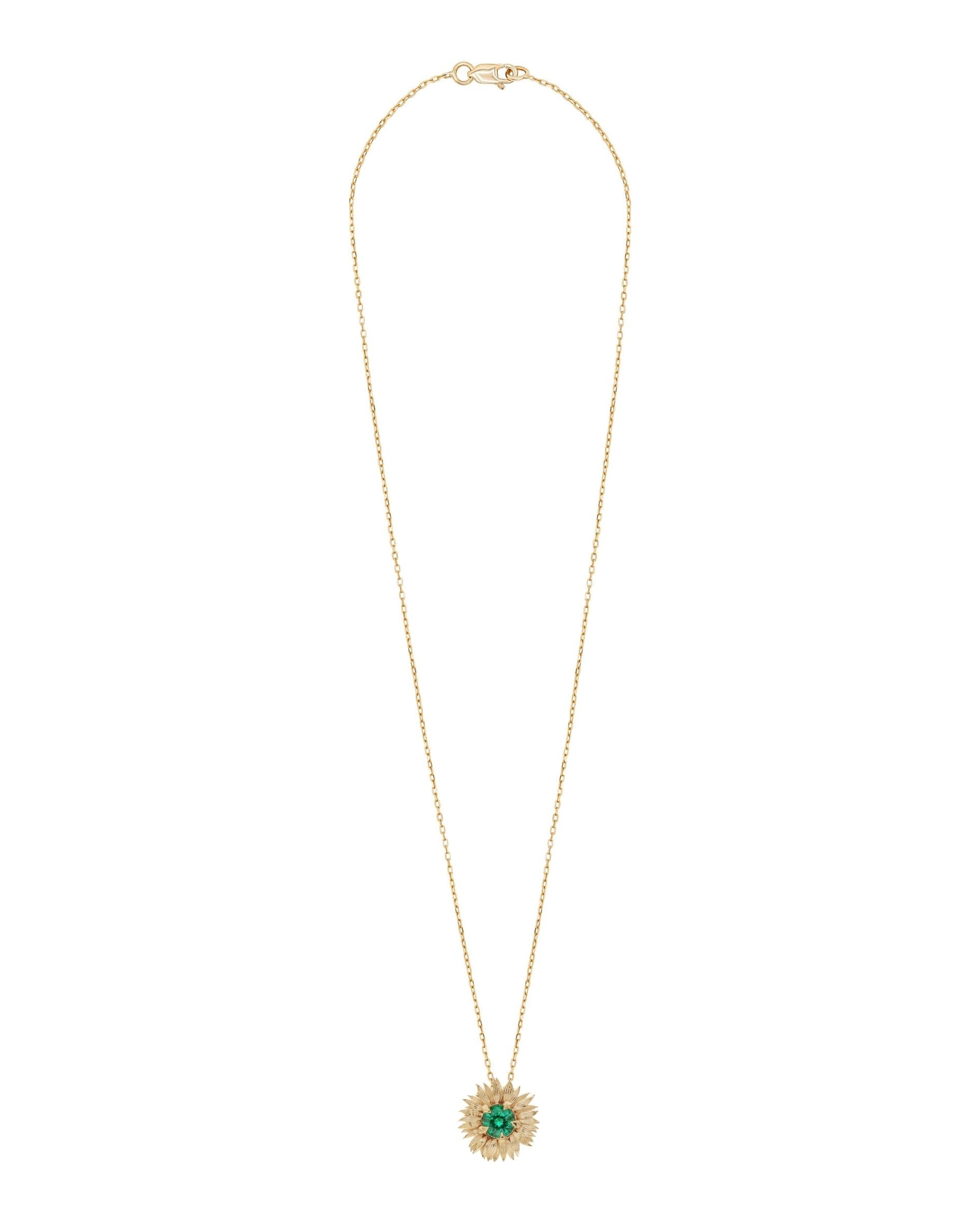 Gold Sunflower necklace with a green pendant on a white background
