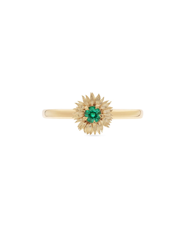 Gold Sunflower ring with a green gemstone on a white background