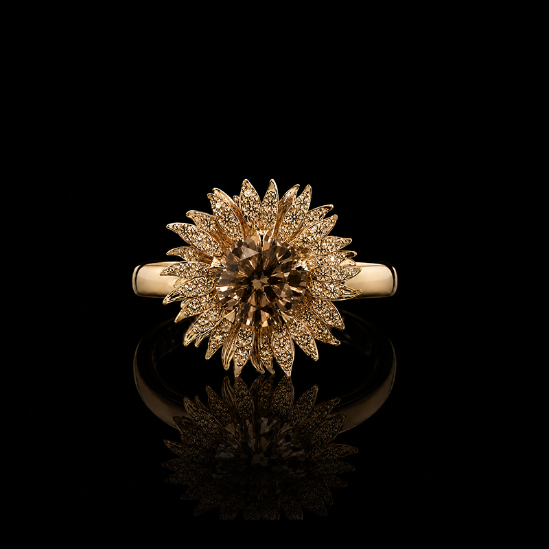 A gold ring with a large, intricate flower-like cluster of small clear stones surrounding a central brown gemstone, displayed on a reflective black surface.