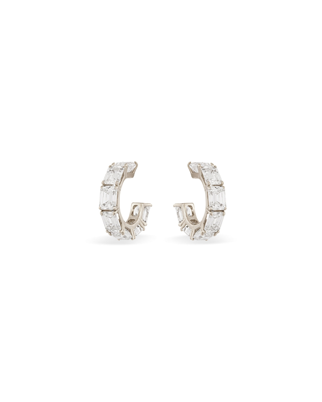 Small white gold diamond hoops with emerald cut white diamonds on a white background