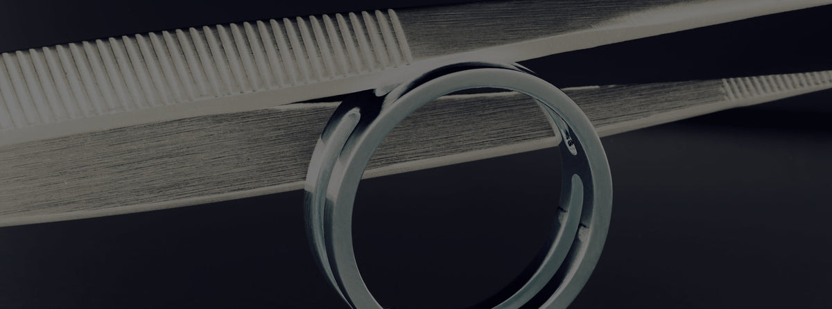 Close up of a tweezer holding a ring