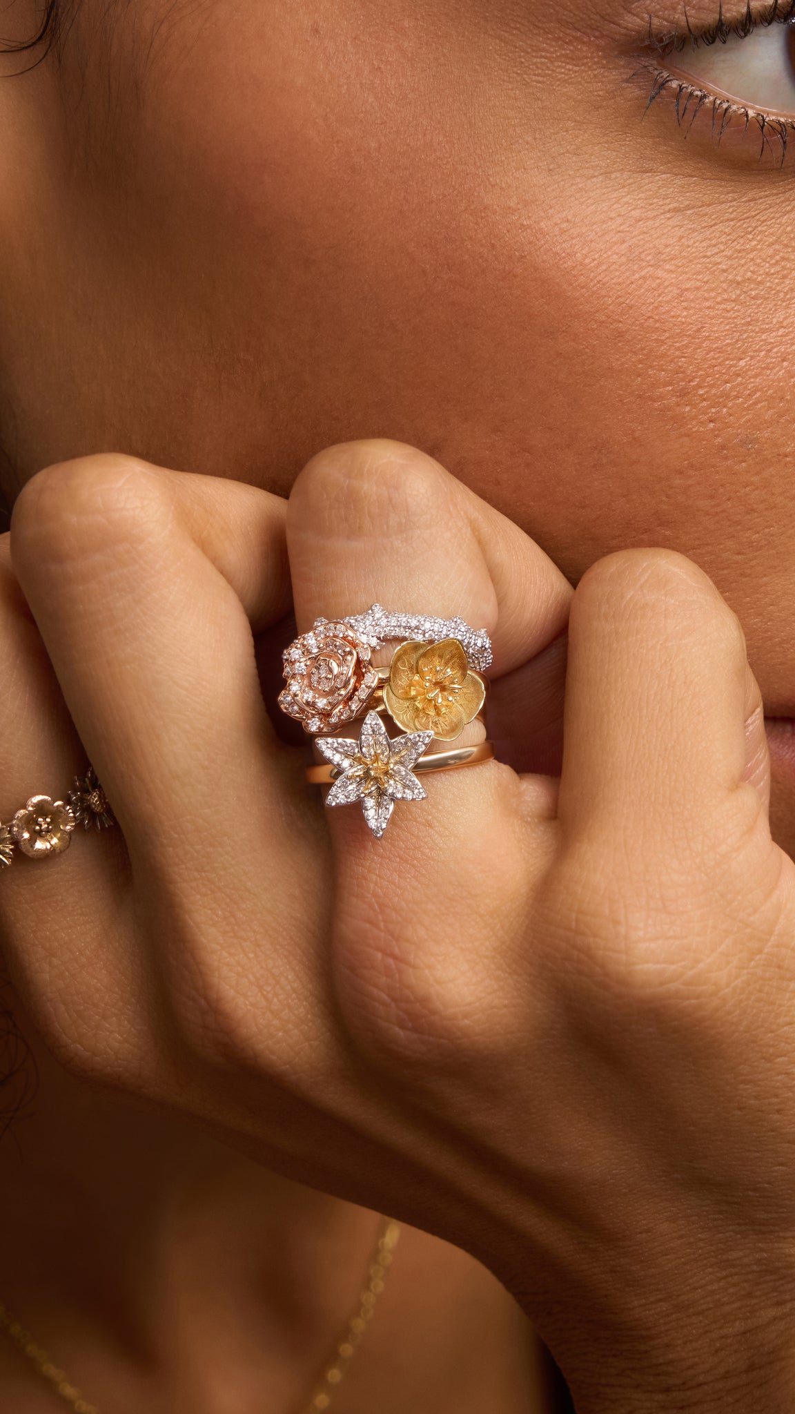 Close-up of a hand wearing multiple rings with gemstones.