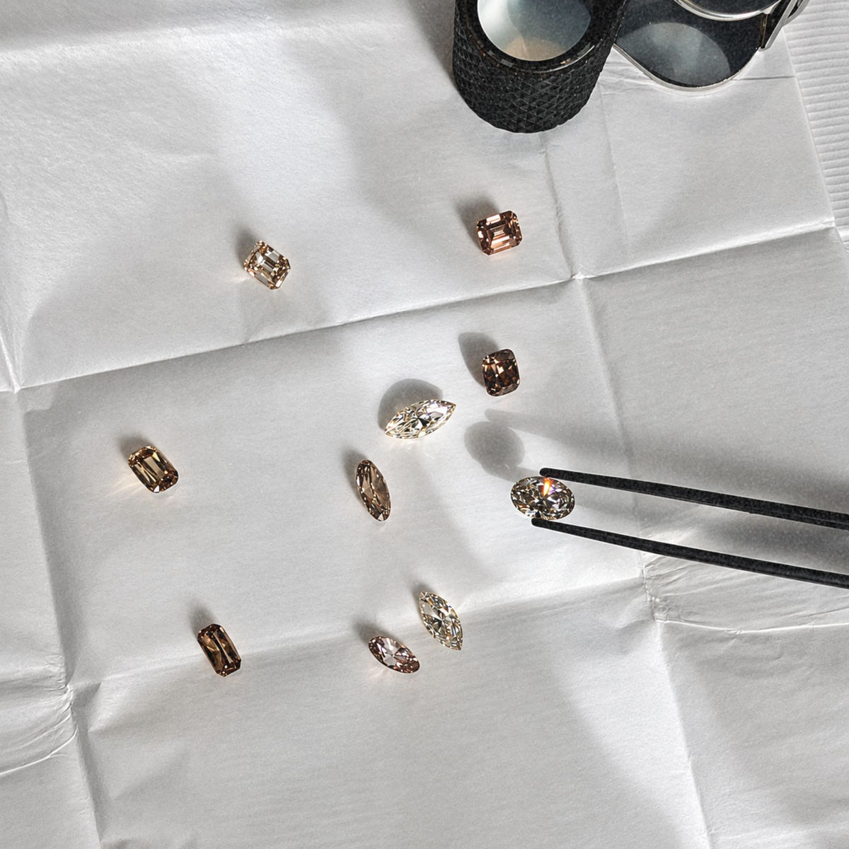 Loose diamonds being selected with tweezers